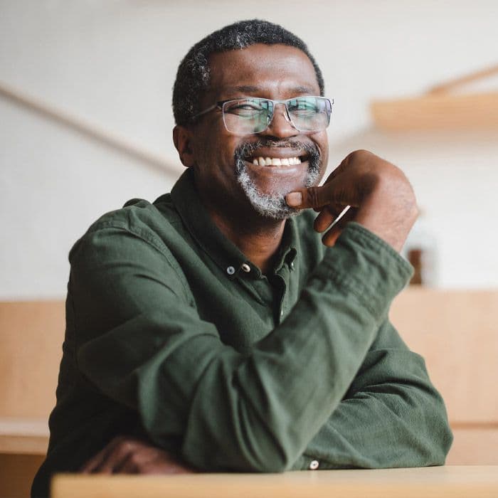 An elderly Black man smiling